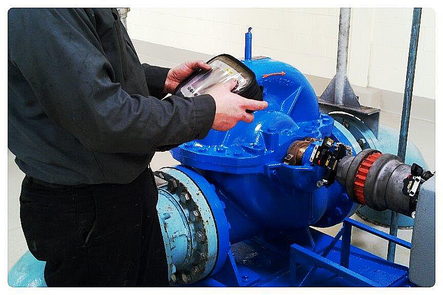 Man laser aligning a pump